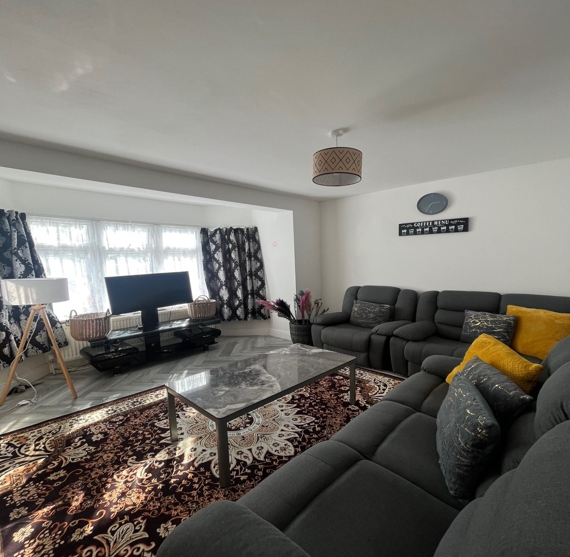 A warm, homely family contact room with comfortable seating, books and toys